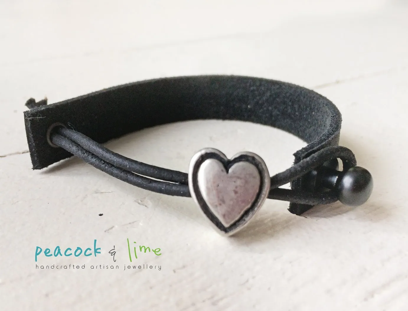 simple modern single strap leather bracelet with pewter heart slider